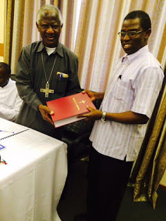 TEC Chairman Rt. Rev. Tarcisius Ngalalekumtwa (left) Receives a copy of the Missal from Rt. Rev.  Salutaris Libena, TEC Bishop  Chairman of Liturgy Commission