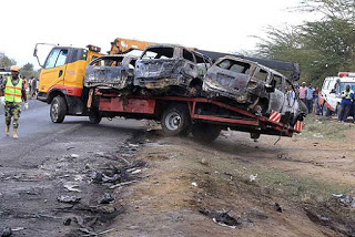 The aftermath of the Naivasha accidents,  Burnt vehicles being removed from the accident scene
