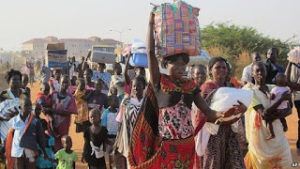 S. Sudanese refugee women cross over Ugandan border last year following the war