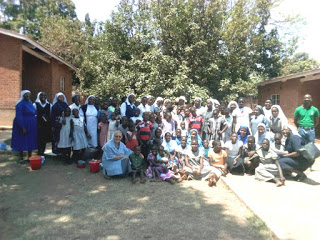The Nuns in a group photo with the Children