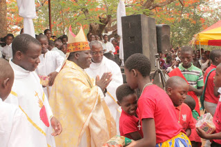 Archbishop Msusa Receives gifts from children  during the Celebrations of the Holy  Childhood in the Archdiocese of Blantyre