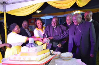 The Bishops assisting the women to cut a cake to  crown the fundraising  dinner