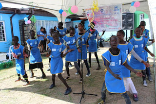 Refugee children singing welcome song
