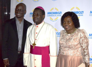 From Left The new CEO of Mkombozi Bank Mr. George Shumbusho, Co-President of Mkombozi Bank Most Rev. Beatus Kinyaiya, OFM. Cap. Archbishop of Dodoma and outgoing CEO of Mkombozi Bank Mrs