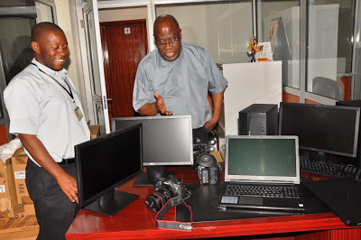 The Secretary General of the Uganda Episcopal Conference, Msgr. John Baptist Kauta (right) and the Executive Secretary of the UEC Social Communication Department, Rev. Fr. Philip Odii inspects the new media equipment upon delivery. 