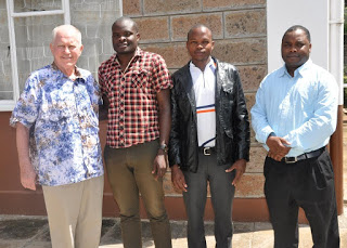 Cornelius Opollo (Second Left in Checked Shirt) Kenyan Representative at The Pre-Synod Meeting in Rome, during his visit to AMECEA Secretariat in Nairobi with Rev. Fr. Joseph Healey, MM, and Colins Ongoma from Ngong Diocese. On extreme right is Rev. Fr. Emmanuel Chimombo Coordinator AMECEA Pastoral Department 