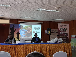 Rev. Fr. Cleophas Lungu (Center) speaking at the launch of   Caritas Zambia Strategic Plan 2018-2022