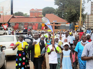 A boy carries a cross as he leads other pilgrim during the 2016 'Walk of Faith' pilgrimage