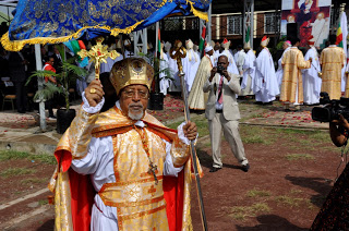 The Main Celebrant Cardinal Berhaneyesus Blesses  the Congregation at the beginning of the Opening Mass, According to Ethiopian Rites, Blessings are imparted using Ethiopian Cross as opposed to Latin Rites where Bishops bless By Hand