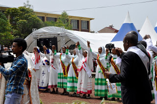 Women dressed in colourful traditional dresses participates during the Opening Mass