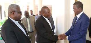 President Edgar Lungu shake hands with Vice Chair of the Congo Conference of Catholic Bishops, Bishop Fridolin Ambongo whilst Secretary General Fr. Donatien Nshole looks on during meeting with the President at State House