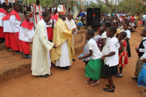 Children giving their offerings to the Archbisho copy