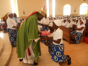 Archbishop Chama receiving gift from a member of CWO