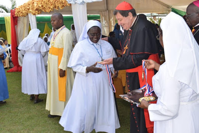 Sr. Susan Clare Ndezu of the Little Sisters of Mary Immaculate of Gulu Receives a medal From Cardinal De Avis as a sign of distinguished service to ARU