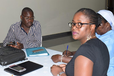 CRS SCORE ECD Zambia Project manager Ms. Bertha Mpepo looking at the camera together with her counterpart Mr. Tobias Opiyo of Kenya during a training at Pine Cone Hotel in Kisumu, Kenya. Photo by Sr. Grace Candiru.