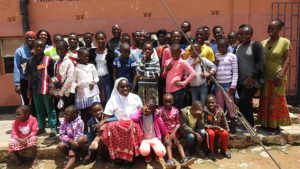Sister Nakambo posing for a photo with children