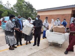 Tamani (left) handing over the equipment