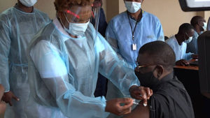 Bishop Charles Kasonde receiving Covid-19 injection
