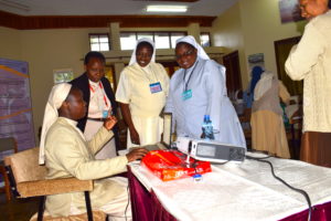 Participants in an ACWECA formation workshop consult with Sr. Jacinta Auma Opondo, (Left - seated), Credit; ACWECA