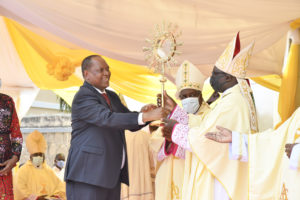 Minister for Constitution and Legal Affairs, Prof. Palamagamba Kabudi giving a present of Monstrancy to Vice President TEC Bishop Flavian Kassala during the opening of Nation Eucharistic Conference