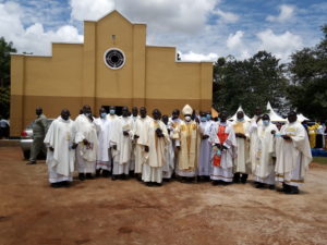 Rt. Rev. Santus Lino Wanok flanked by the priests in a group photo after the official opening of St. Peter Claver Ober Parish in Lira