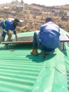 MARK DODOMA AND HIS FRIEND INSTALLING SOLAR PANELS