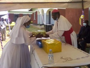 Rt. Rev. Santus Lino Wanok, the Bishop of Lira Diocese receiving a gift from the religious sisters on his 35th anniversary in Priesthood.