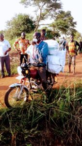 a farmer ferrying his cassava product on motor cycle for sale in the market