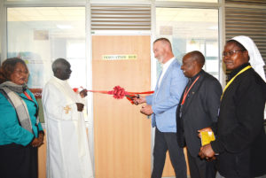 Most Rev. Philip Anyolo the Archbishop of Nairobi, Dr. Marc J. Holley, the Vice President of Conrad Hilton Foundation (CNHF)  cutting the tape during   the opening