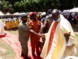 Vicar General Monsignor Valente Innocent Opio receiving receiving offertory during the procession