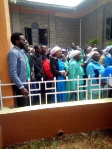 Some Catholic faithful watch as Archbishop Anyolo blesses the new chapel.