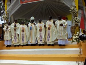 Bishop Kibira with newly ordained priests and deacons