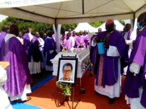 Rt Rev Sanctus Lino Wanok of Lira diocese flanked by the priests blessing the Casket of late Fr Sebhatleab Ayele