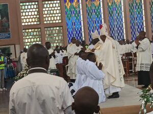 His Eminence John Cardinal Njue & His Grace Philip Anyolo laying hands on new priests