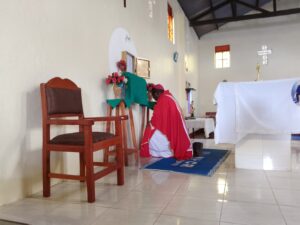 BISHOP KIBIRA KNEELING BEFORE THE TUBRINAC