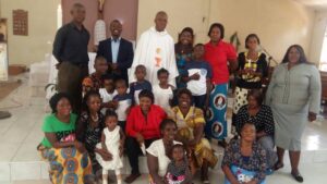 Father John Rurangwa with Christians