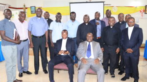 Fr. John Baptist Kaganda (front -left) in a group photo with incharges of Small Christian communities after meeting