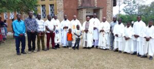 MSGR NDUGWA IN A GROUP PHOTO WITH SOME OF THE RETURNEES AND CLERGY