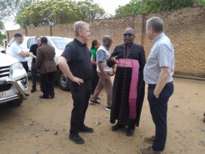 Bishop Stima (middle) interacts with bishops Fintani and Dempsey