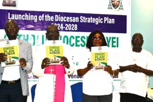 Bishop and government official posing for photo during the launching of the strategic plan