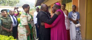 BISHOP KIBIRA HUGGING THE KING
