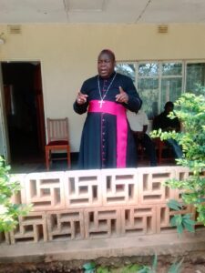 Bishop Chaima speaking to people during the donation of maize