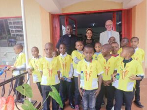 Fr. Bonaventure Luchidio, AMECEA Correspondent, Fr. Anthony Chantry (MHM) with a Section of PMC children Shortly after the Children Christman Event on January 6, 2024