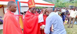 BISHOP KIBIRA BLESSING MR CLEOUS AT KAKONE PARISH