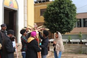 H.G. Archbishop Menghisteab leading the opening prayer & handing over the big cross to Youth