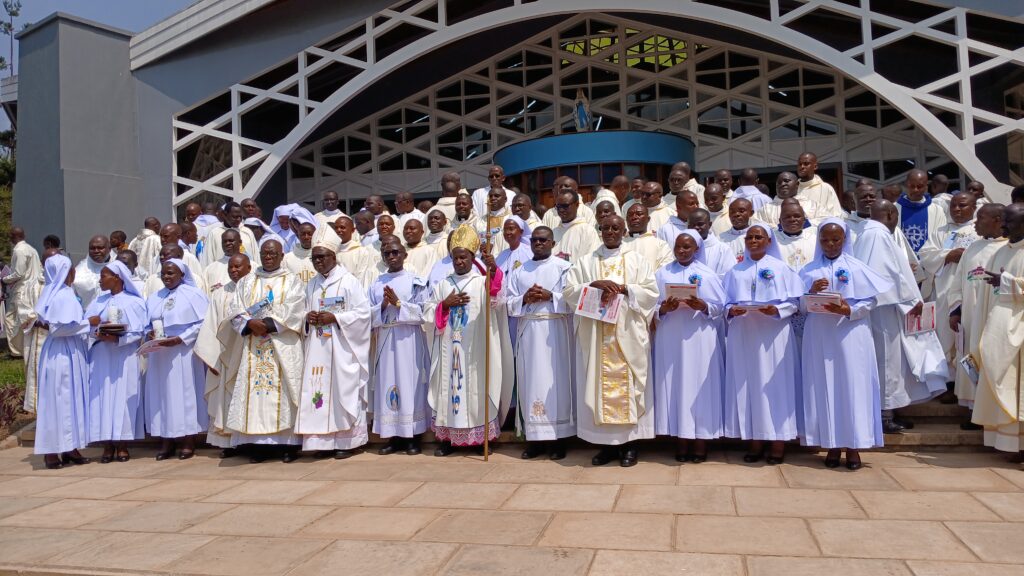 BISHOP MUHIRWA AND BISHOP KIRABO WITH THE CLERGY AND JUBILANT