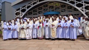 BISHOP MUHIRWA AND BISHOP KIRABO WITH THE CLERGY AND JUBILANT