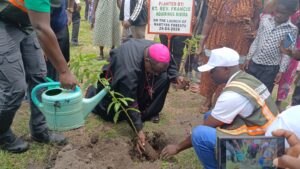 BISHOP KIBIRA PLANTING A TREE DURING THE LAUNCH