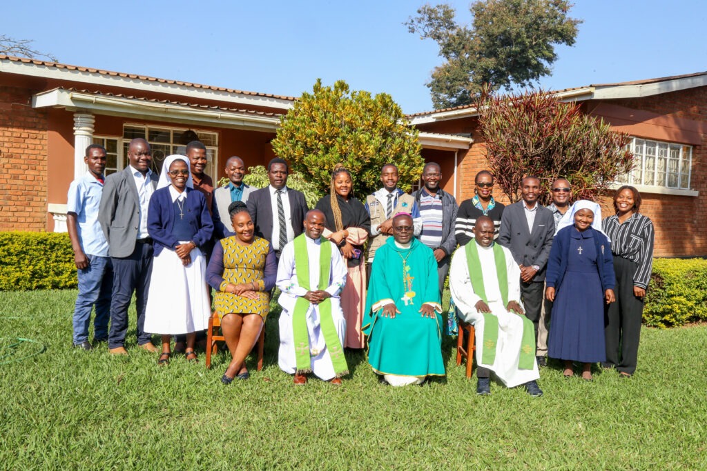 Bishop Nyirenda poses for a group photo with workshop participants and facilitators