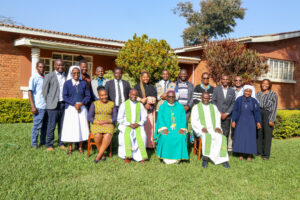 Bishop Nyirenda poses for a group photo with workshop participants and facilitators